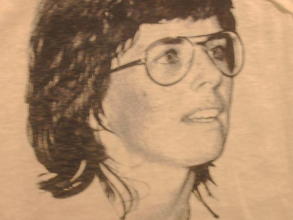 Portrait of Billie Jean King and the final match score over Bobby Riggs.