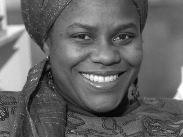 Black and white photograph of an African American women with her hair covered by a scarf.