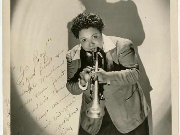 Black-and-white autographed photograph of Tiny Davis playing the trumpet