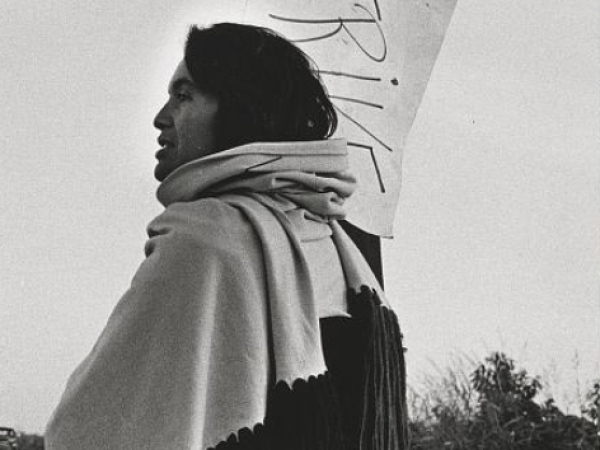 Dolores Huerta in profile. She holds a sign that reads &quot;STRIKE.&quot;