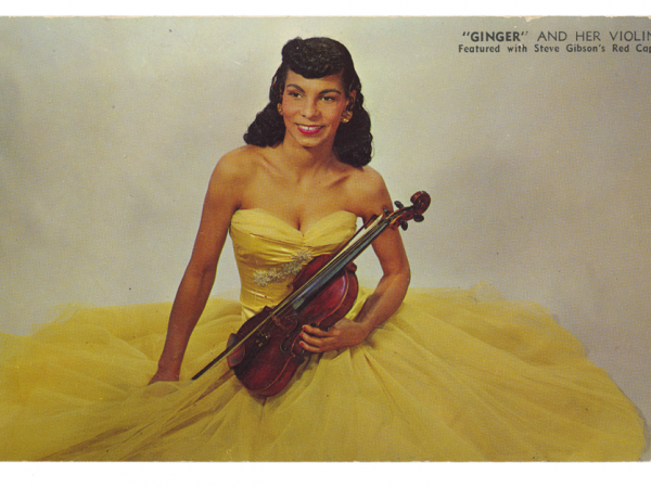 Ginger in a yellow gown holding a violin.