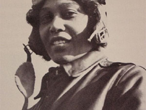 Sepia photo of Janet Harmon Bragg wearing flight goggles and a suit