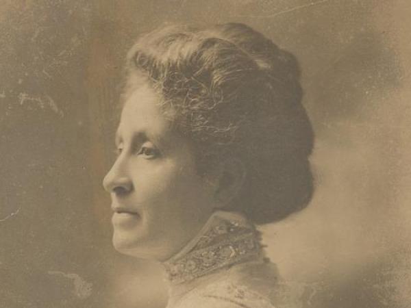 Mary Church Terrell in profile. She wears a dress with a high collar and fringed sleeves.