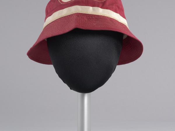 A red, canvas, pledge bucket hat with an off-white band around the base of the crown and a white patch with the word Pyramid and small pyramid symbols at the front of the crown