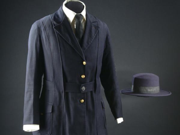  jacket of navy blue with gold buttons and navy A-line cloth skirt.