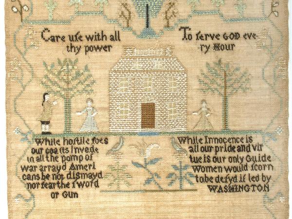 Betsey’s sampler includes three distinguishing features of Rhode Island samplers; trumpeting angels with embroidered faces, queen stitch flowers, and a three-story house. 