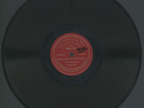 Record that reads &quot;Commodore: Classics in a Swing. 526-A. Strange Fruit. Billie Holiday and Her Orchestra. Piano Interlude by Sonny White.&quot;