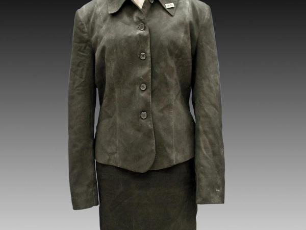 Grey jacket and skirt, with a small gold lapel pin