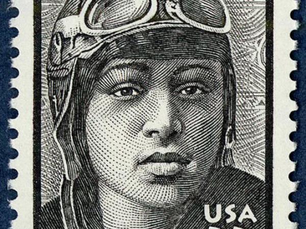 alt=&quot;Stamp featuring an Etching of Bessie Coleman wearing her flying helmet and goggles &quot;