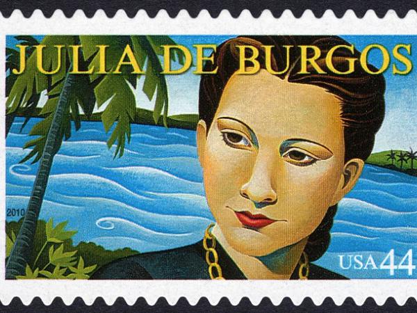 Painting of Julia De Burgos&#039;s face in front of a river with palm trees on either side. Her name is printed at the top of the stamp.