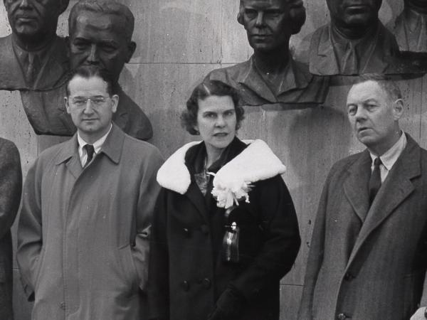 Group of people stand in front of a wall