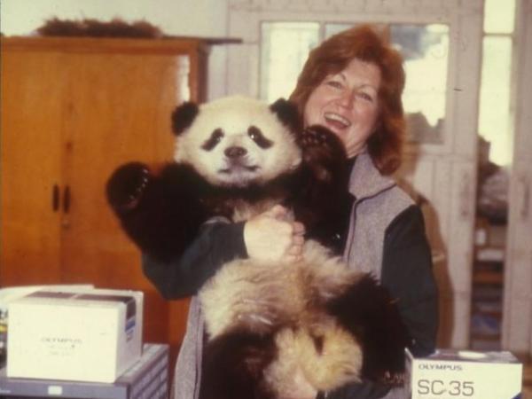 Dr. JoGayle Howard holds a young panda in her arms