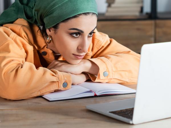 woman focused on online webinar while learning at home