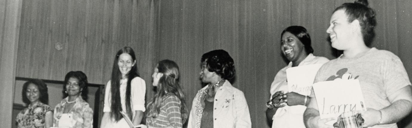 group of women standing on stage