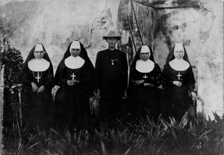 Four nuns and a priest in uniform