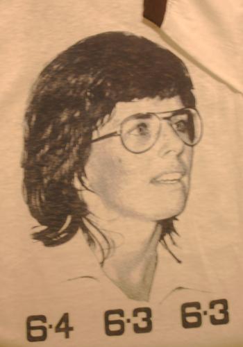 Portrait of Billie Jean King and the final match score over Bobby Riggs.