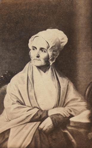 Lucretia Mott seated while wearing a bonnet and a shawl with her right hand crossed over her left arm