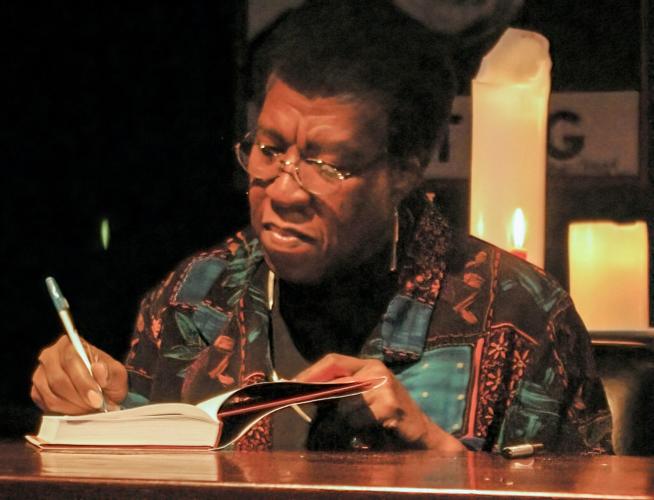 Photo of Octavia Butler signing a book