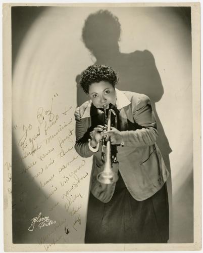 Black-and-white autographed photograph of Tiny Davis playing the trumpet