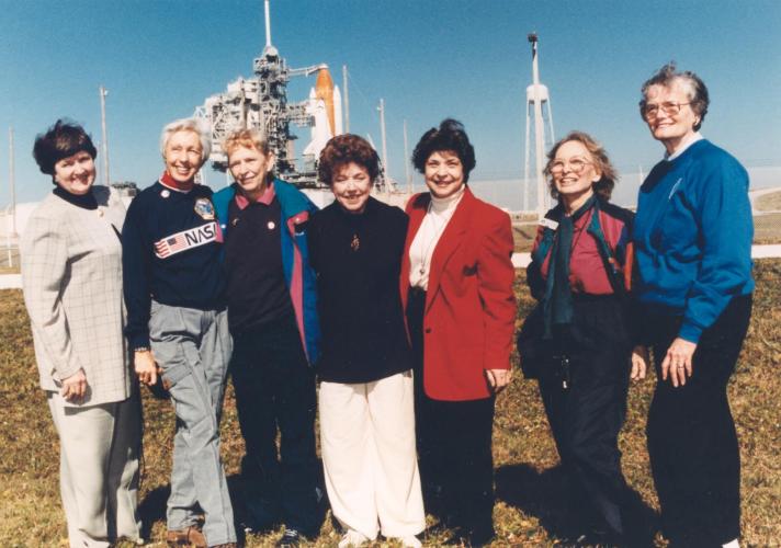 Seven women stand outside Launch Pad 39B near the Space Shuttle Discovery