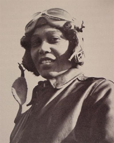 Sepia photo of Janet Harmon Bragg wearing flight goggles and a suit