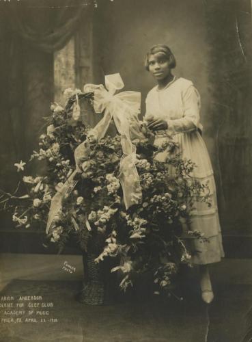 Anderson, 21, poses next to a basket of roses almost as tall as she is. 