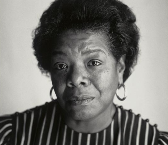 Black and white photograph of Maya Angelou wearing hoop earrings and a striped shirt