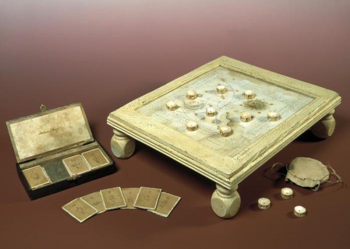 Aged set of cards and a fortune telling board with markers