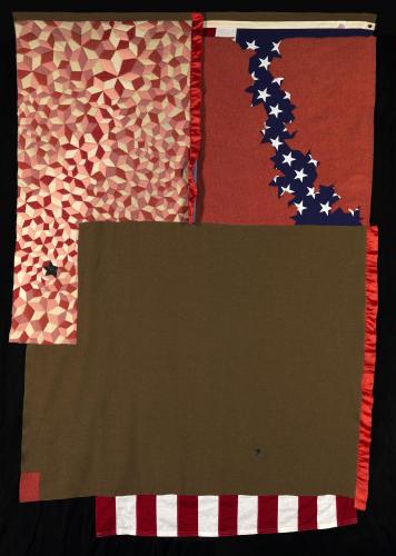 Fabric collage with American flag underneath red and brown fabric. Parts of the flag are revealed.