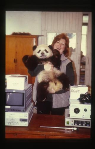 Dr. JoGayle Howard holds a young panda in her arms