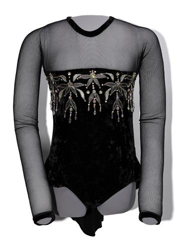 Kristi Yamaguchi’s dancing costume from “Stars on Ice.” There are mesh sleeves attached to a black bodice with jewels across the chest. 