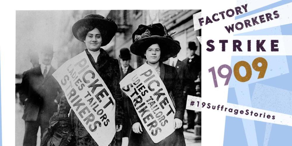 Two strikers look at the camera. They wear large hats and sashes that say &quot;Picket Ladies Tailors Strikers.&quot; Men behind them stare. Text on image: Factory Workers Strike 1909