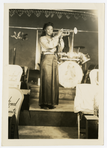 Young African American woman plays the trumpet.